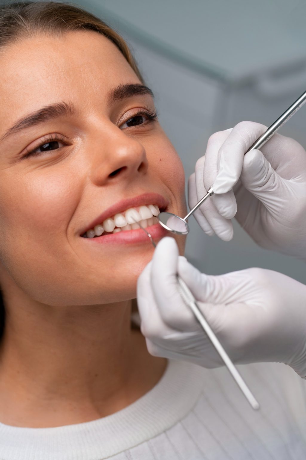 Smiling woman during teeth whitening check-up