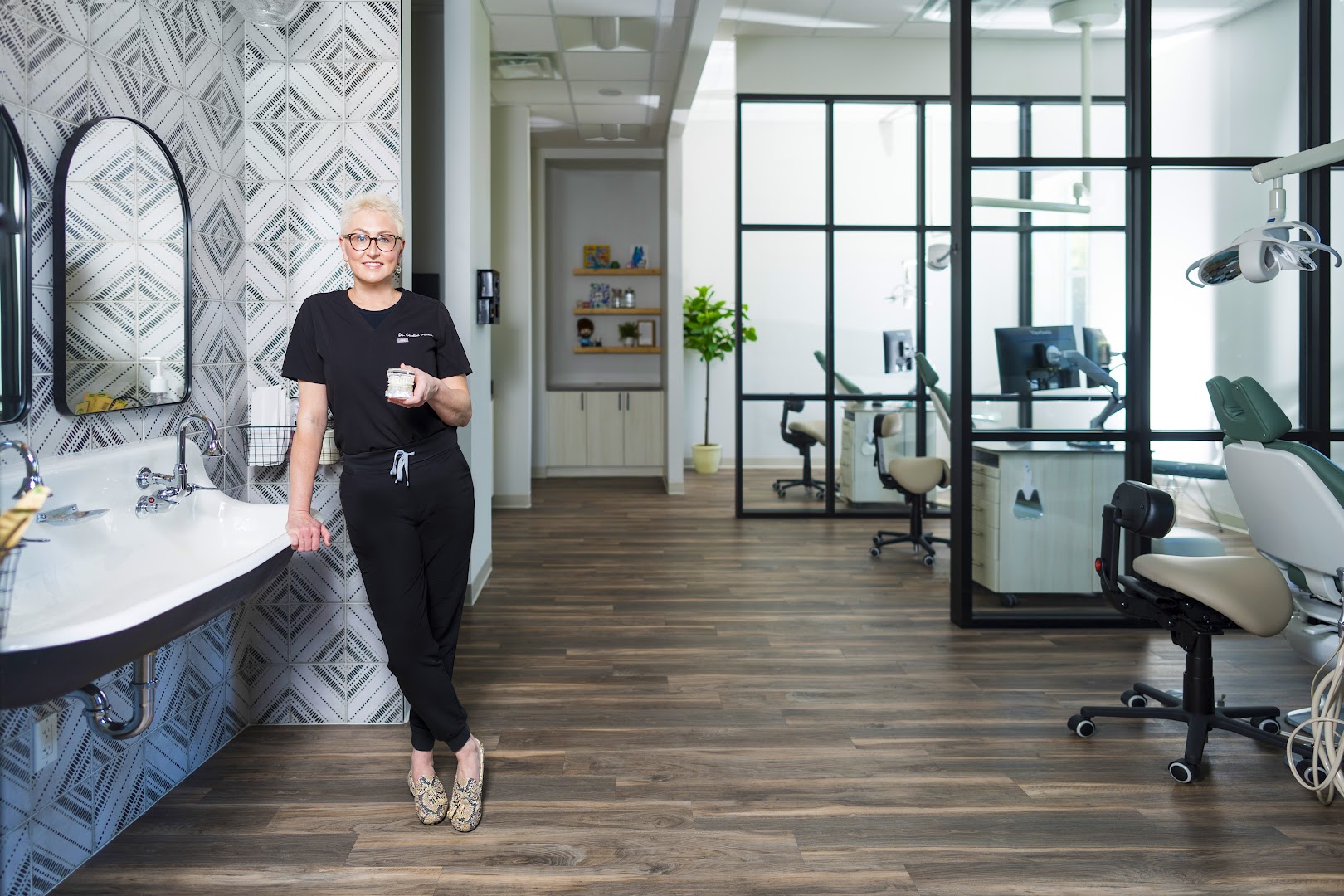 Smiling female dentist in modern orthodontic office