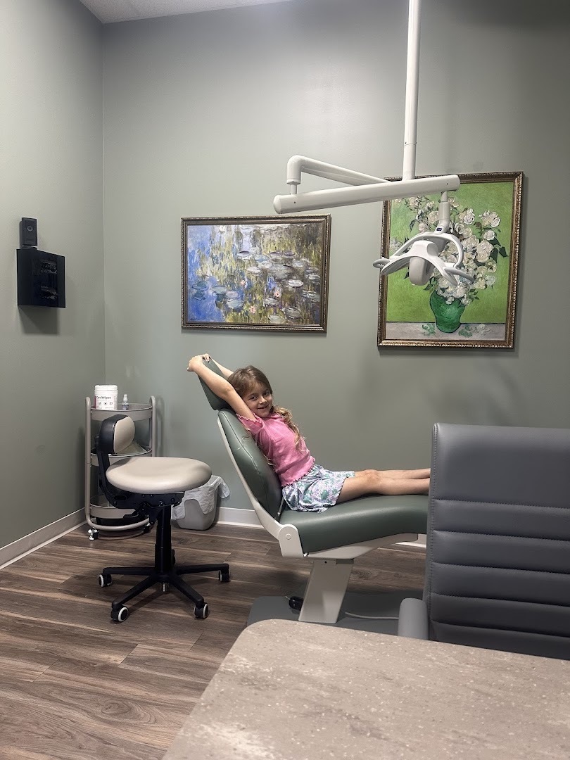 Smiling young patient in dental chair at Artful Orthodontics