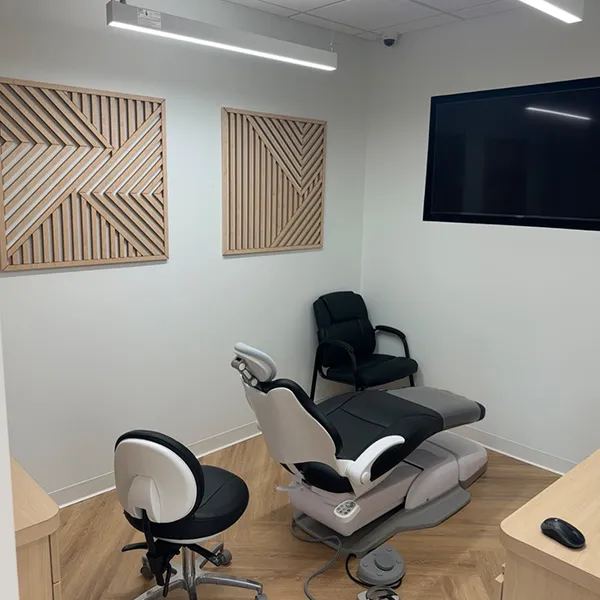 The welcoming reception area of the orthodontic practice, with comfortable seating and warm lighting.
