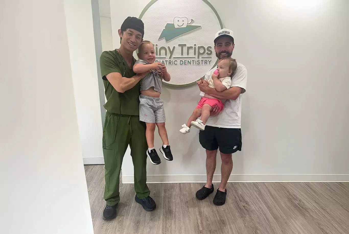 Dr. Jian Lee with young patients and their dad at Tiny Trips Pediatric Dentistry