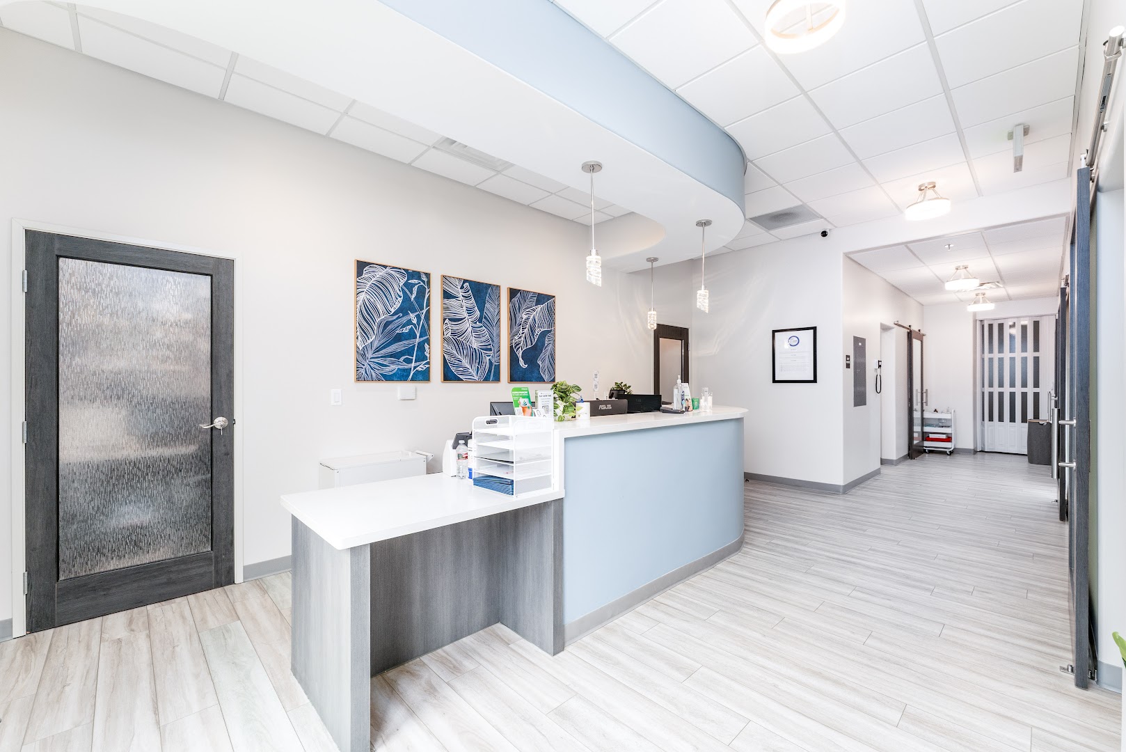 Coastal Endodontic Studio reception area with botanical wall art