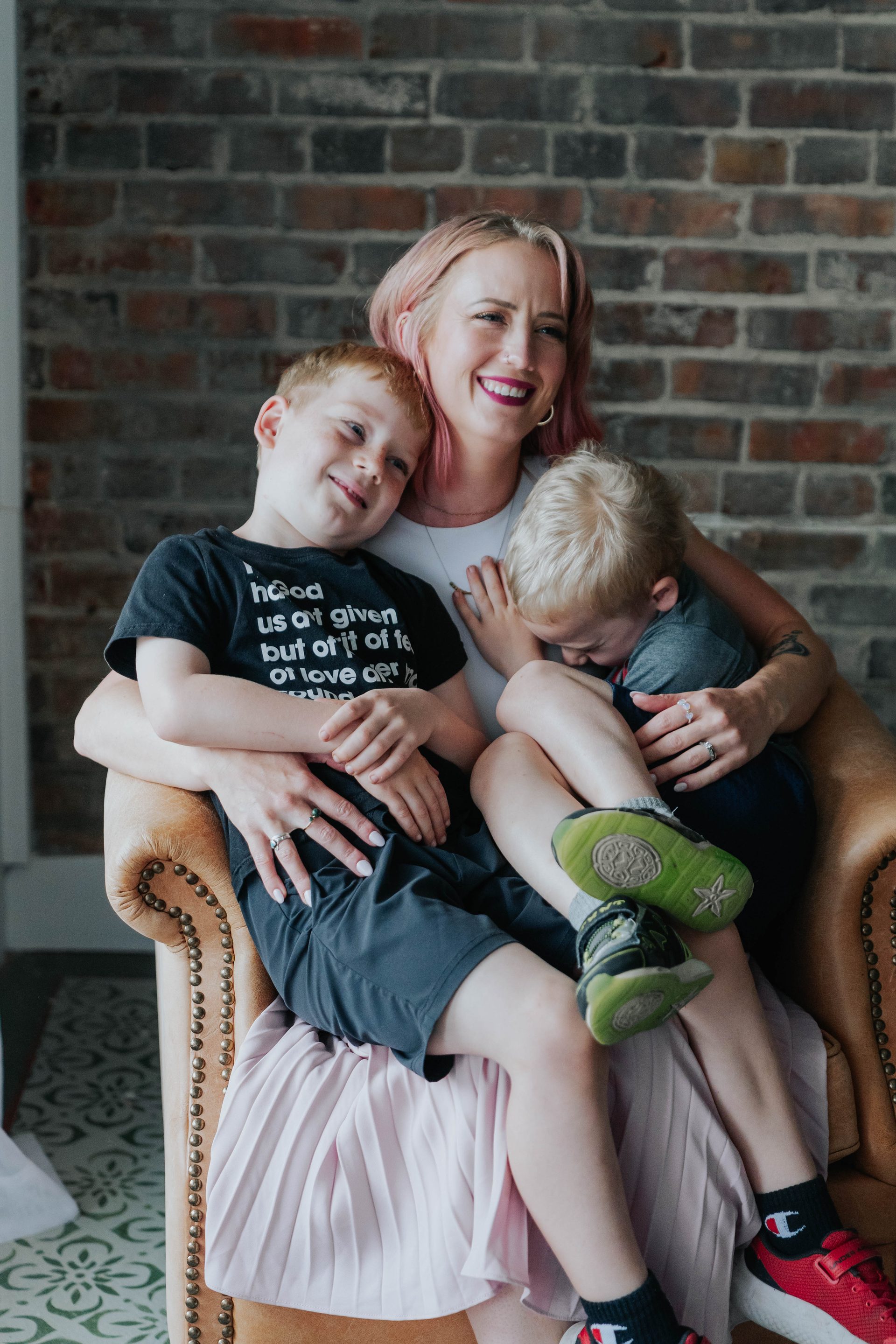 A mother holding her two children at a Rural Salute event