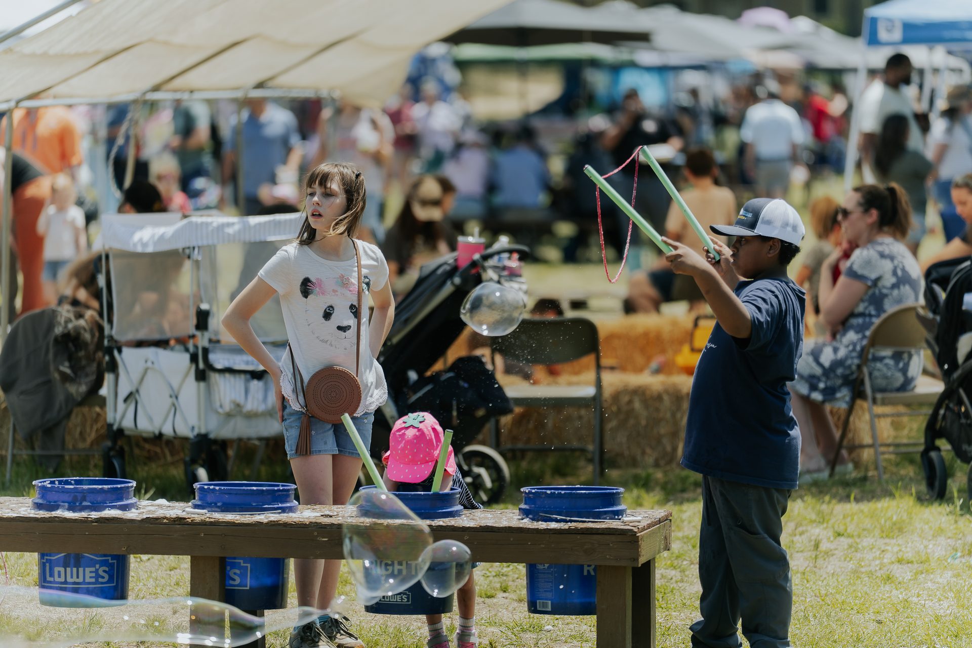 Visitors browsing vendor tents at a Rural Salute event
