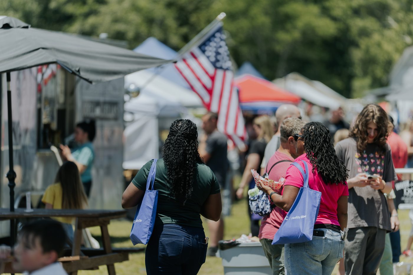 Vendors and visitors at an outdoor Rural Salute event