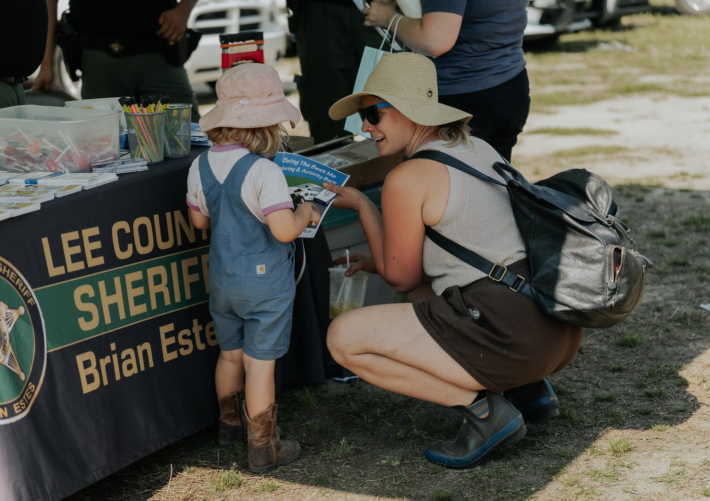 A family at a sheriff's office booth during a Rural Salute event