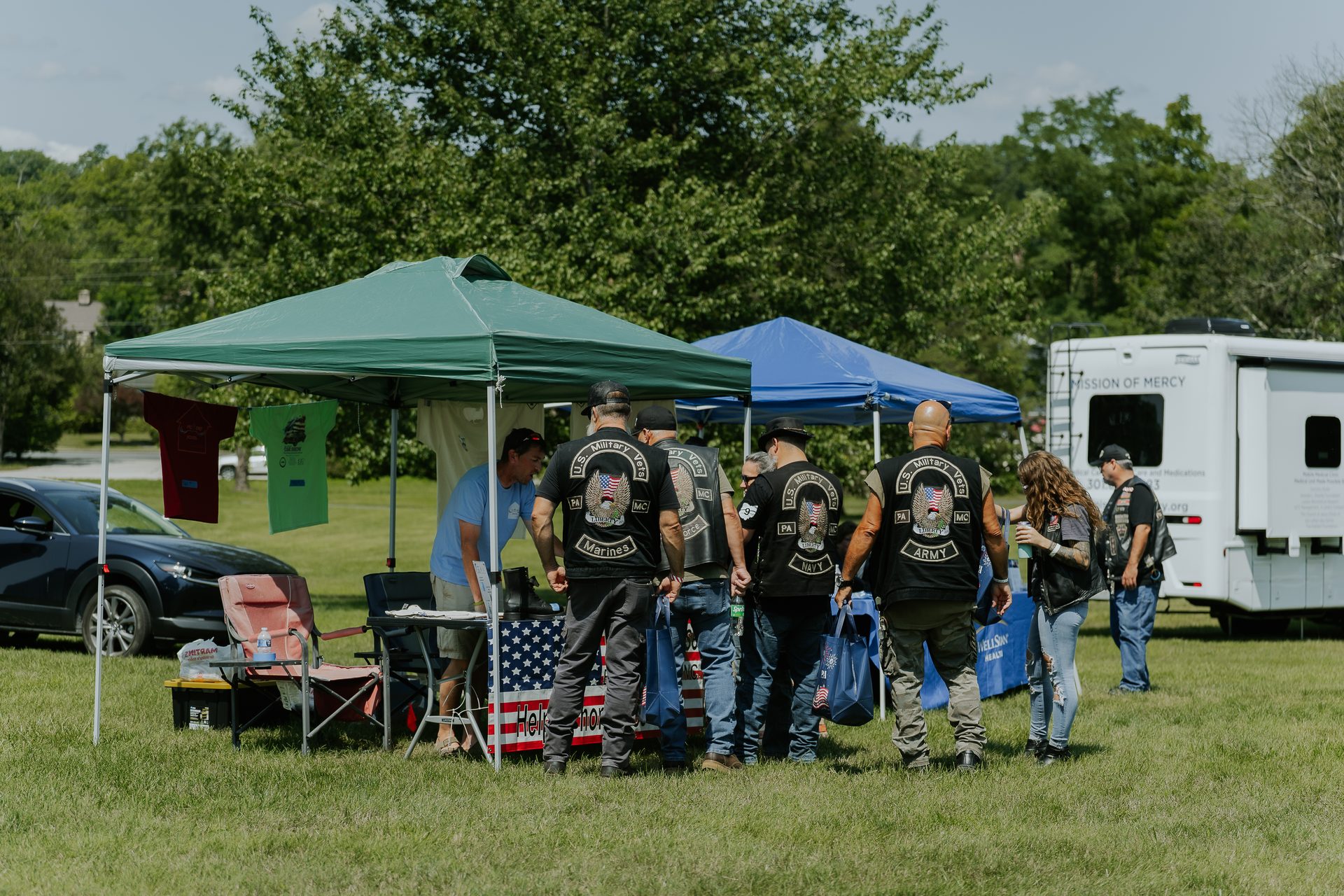 Veterans gathered at tents during an outdoor Rural Salute event